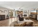 Bright living area with hardwood floors, a fireplace with stone surround, and access to the outdoors at 11021 N 64Th Ln, Glendale, AZ 85304