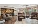 Cozy living room boasts hardwood floors, a built-in bar, and comfortable seating for relaxing and entertaining at 11021 N 64Th Ln, Glendale, AZ 85304