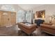 Elegant living room with hardwood floors, a decorative window, and leather furniture at 11021 N 64Th Ln, Glendale, AZ 85304