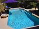 Refreshing pool with tiled edges, surrounded by lounge chairs and lush landscaping for relaxation at 11021 N 64Th Ln, Glendale, AZ 85304