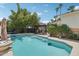 Sparkling pool featuring integrated steps, surrounded by lush greenery and a shaded pergola at 11021 N 64Th Ln, Glendale, AZ 85304