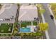 This aerial view showcases the expansive backyard with a sparkling pool, lush greenery, and outdoor seating at 11705 W Luxton Ln, Avondale, AZ 85323