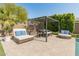 Private backyard featuring a shaded pergola, outdoor seating, and manicured landscaping for a tranquil retreat at 11705 W Luxton Ln, Avondale, AZ 85323