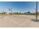 Open-air basketball court with modern hoops, clear markings, and nearby playground providing recreational opportunities at 11705 W Luxton Ln, Avondale, AZ 85323