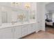 Bright bathroom with and vanity, door to closet, and view to Primary bedroom at 11705 W Luxton Ln, Avondale, AZ 85323
