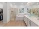 Bright bathroom featuring glass shower, soaking tub and and vanity at 11705 W Luxton Ln, Avondale, AZ 85323