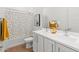 A lovely bathroom featuring a dual sink vanity and shower with stylish curtain at 11705 W Luxton Ln, Avondale, AZ 85323