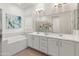 Bright bathroom with soaking tub and and vanity at 11705 W Luxton Ln, Avondale, AZ 85323