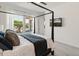 Bright bedroom with backyard view from window and tv mounted on wall at 11705 W Luxton Ln, Avondale, AZ 85323