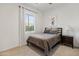 Cozy bedroom featuring neutral paint, carpet, and picture window at 11705 W Luxton Ln, Avondale, AZ 85323