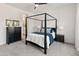 Beautiful bedroom featuring canopy bed frame with white shiplap wall and view to Primary bath at 11705 W Luxton Ln, Avondale, AZ 85323