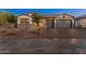 Charming home exterior with a three-car garage, desert landscaping, and inviting curb appeal, providing an instant welcome at 11705 W Luxton Ln, Avondale, AZ 85323