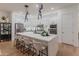 Sleek and stylish kitchen with a large center island, stainless steel appliances, and modern pendant lighting at 11705 W Luxton Ln, Avondale, AZ 85323