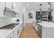 Modern kitchen with stainless steel appliances, a spacious island, and seamless access to the living area at 11705 W Luxton Ln, Avondale, AZ 85323