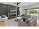 Stylish living room with a chic accent wall, comfortable seating, and sliding glass doors to the outdoor space at 11705 W Luxton Ln, Avondale, AZ 85323
