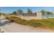 Alamar Park entrance sign on a landscaped median at 4155 S. El Mirage Road, Avondale with a lake in the distance at 11705 W Luxton Ln, Avondale, AZ 85323