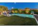 Beautiful backyard with a sparkling pool, lounge area, and lush landscaping, perfect for outdoor entertaining at 11705 W Luxton Ln, Avondale, AZ 85323