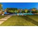 Beautiful backyard with a sparkling pool, lounge area, and lush landscaping, perfect for outdoor entertaining at 11705 W Luxton Ln, Avondale, AZ 85323