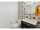 This stylish powder room features unique tile, contemporary fixtures, and designer accents at 11705 W Luxton Ln, Avondale, AZ 85323