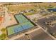 Aerial view of the community's tennis and basketball courts near a parking lot at 11705 W Luxton Ln, Avondale, AZ 85323
