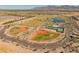 Aerial view of the sports complex in the community with mountains in the background at 11705 W Luxton Ln, Avondale, AZ 85323