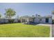 Spacious backyard with lush lawn, covered patio, and privacy wall, perfect for outdoor entertaining and relaxation at 1422 E Windsor Ave, Phoenix, AZ 85006