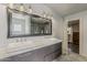 Bright bathroom boasts double sinks with marble countertops and a large framed mirror at 1422 E Windsor Ave, Phoenix, AZ 85006