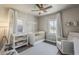 Charming Bedroom features a white crib, neutral tones, wood floors, and natural light from two windows at 1422 E Windsor Ave, Phoenix, AZ 85006