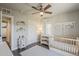 Neutral Bedroom featuring a wooden crib, gray walls, wood floors, and bright white bookshelves at 1422 E Windsor Ave, Phoenix, AZ 85006