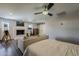 Cozy bedroom with a fireplace, ceiling fan, Peloton exercise bike, and wood-look flooring at 1422 E Windsor Ave, Phoenix, AZ 85006