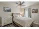 Cozy bedroom with a comfortable bed, a white dresser, and natural light from the window at 1422 E Windsor Ave, Phoenix, AZ 85006