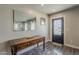 Cozy entryway featuring a wood accent table, decorative mirror, and updated glass door at 1422 E Windsor Ave, Phoenix, AZ 85006
