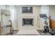 Modern fireplace featuring clean design, mounted TV, exercise bike, and wood-look flooring at 1422 E Windsor Ave, Phoenix, AZ 85006