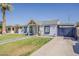 Charming home featuring a lush lawn, sidewalk, driveway, and painted window and trim accents at 1422 E Windsor Ave, Phoenix, AZ 85006