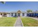 Charming single-story home with beautiful green lawn, stone pathway, and painted accents at 1422 E Windsor Ave, Phoenix, AZ 85006