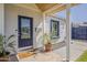 Inviting front porch with glass door, wood beam accent, and potted plant details at 1422 E Windsor Ave, Phoenix, AZ 85006