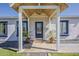 Charming front porch with a glass door, wood beam accents and potted plants at 1422 E Windsor Ave, Phoenix, AZ 85006