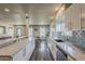 Spacious kitchen with white cabinets, gray backsplash, and an open design connecting to the dining and living areas at 1422 E Windsor Ave, Phoenix, AZ 85006