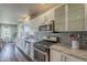 Stylish kitchen with stainless steel appliances, sleek cabinets, modern backsplash, and an open layout dining area at 1422 E Windsor Ave, Phoenix, AZ 85006