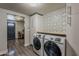 Laundry area with decorative tile, white cabinets, and modern Samsung washer and dryer with wood countertop at 1422 E Windsor Ave, Phoenix, AZ 85006