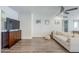 Relaxing living room featuring stylish furniture, ceiling fan, mounted TV, and bright natural light at 1422 E Windsor Ave, Phoenix, AZ 85006