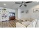 Cozy living room showcases modern decor, wood-look floors, ceiling fan and bright natural lighting at 1422 E Windsor Ave, Phoenix, AZ 85006