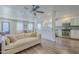 Bright open living room showcasing sleek kitchen, ceiling fan, comfortable couch, and natural light at 1422 E Windsor Ave, Phoenix, AZ 85006