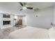 Spacious main bedroom with fireplace, ceiling fan, exercise bike, and wood-look floors at 1422 E Windsor Ave, Phoenix, AZ 85006
