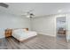 Bright main bedroom features modern design, ceiling fan, wood-look floors and side table at 1422 E Windsor Ave, Phoenix, AZ 85006
