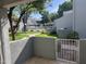 View from the patio with a green lawn, swimming pool, and lush landscaping in a well-maintained community at 220 N 22Nd Pl # 1011, Mesa, AZ 85213
