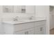 Clean bathroom with double vanity and white cabinetry at 35445 N Seedling St, San Tan Valley, AZ 85144