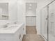 Modern bathroom featuring double vanity sinks and a shower stall at 35445 N Seedling St, San Tan Valley, AZ 85144