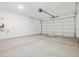Spacious garage with a roll-up door and concrete flooring at 35445 N Seedling St, San Tan Valley, AZ 85144
