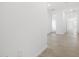 Bright hallway featuring neutral tile flooring, fresh white paint and an open doorway at 35445 N Seedling St, San Tan Valley, AZ 85144